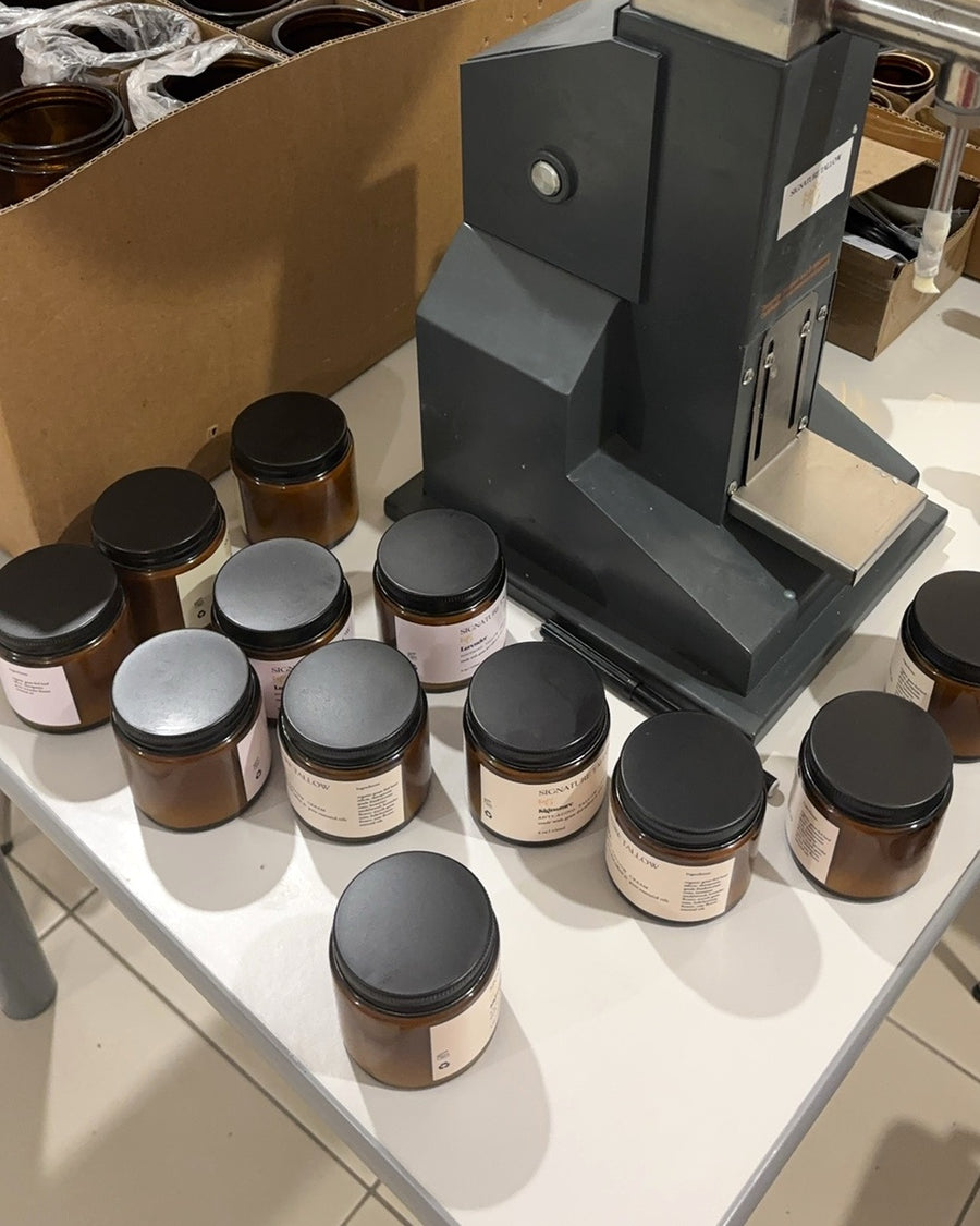 Filling jars by hand on the machine at the Signature Tallow packing station